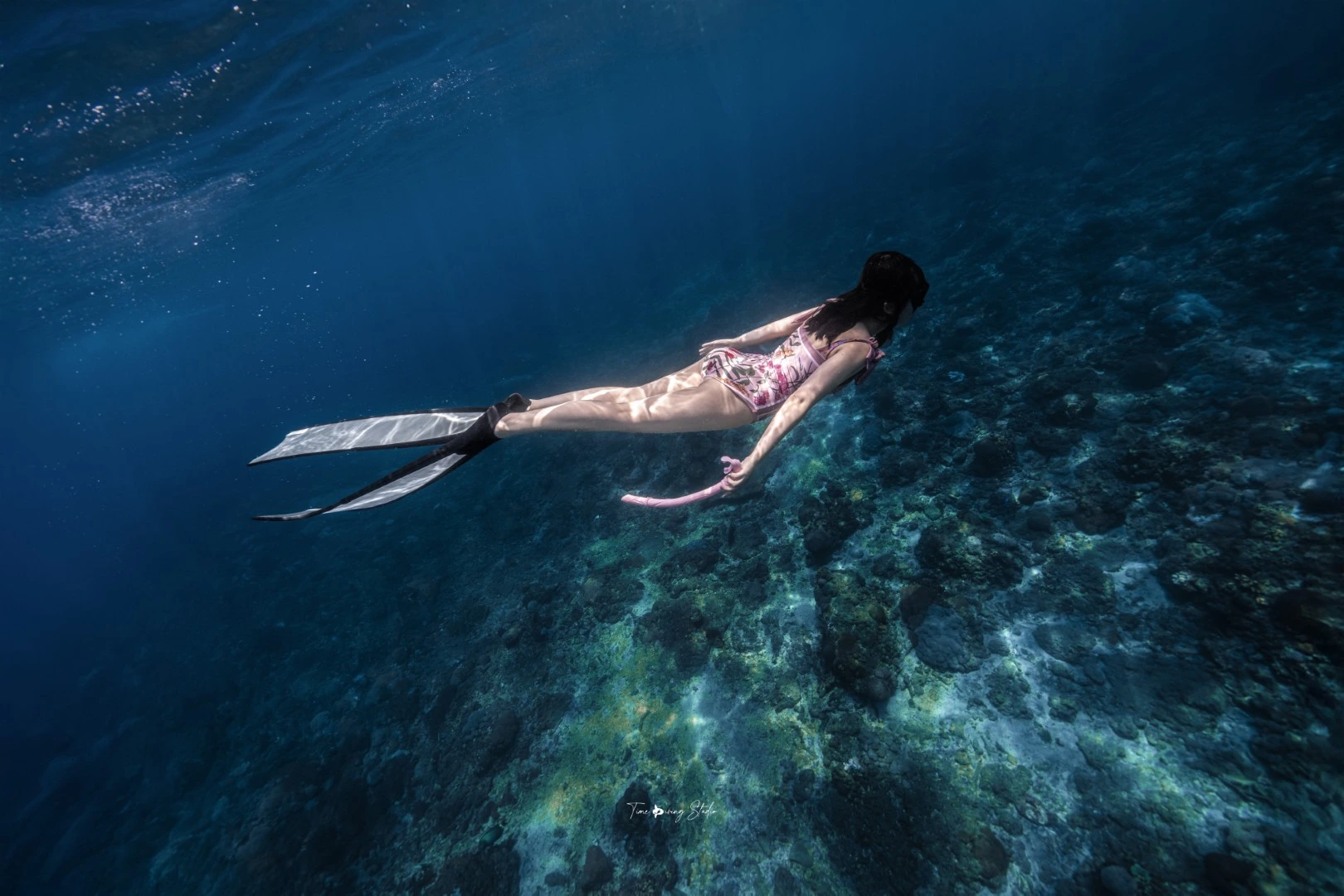 Scuba diving girl coral